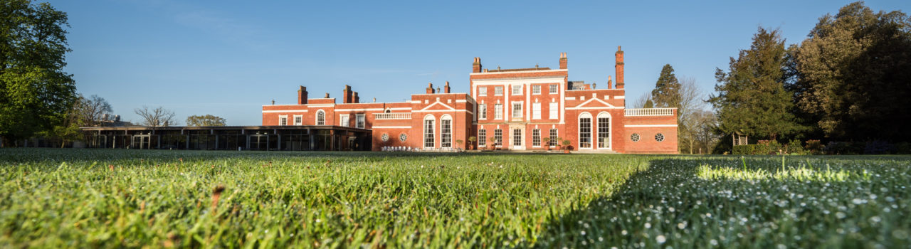 Colour photograph of Hinxton Hall and lawns.